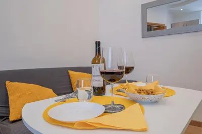 a table with wine glasses and a bottle of wine at Happy Home in Rome