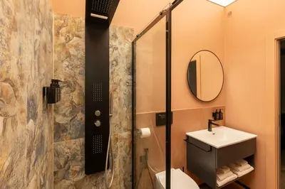 a bathroom with a shower and a toilet and a sink at San Giovanni Luxury Rooms in Rome