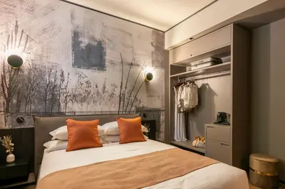 a bedroom with a large bed with orange pillows at San Giovanni Luxury Rooms in Rome