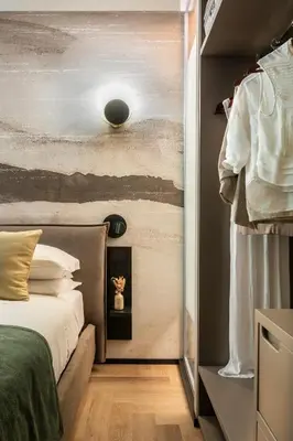 a bedroom with a bed and a wall at San Giovanni Luxury Rooms in Rome