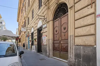 a building with a large wooden door on a street at Pretorius Design Loft - Near Termini Station by RHR in Rome