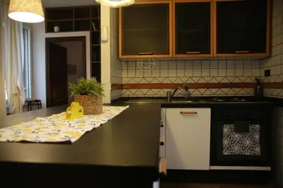 a kitchen with a counter with a sink and a stove at Casa di Egeria al Colosseo in Rome