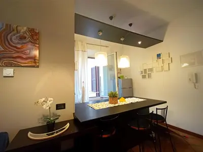 a kitchen with a table and chairs in a room at Casa di Egeria al Colosseo in Rome