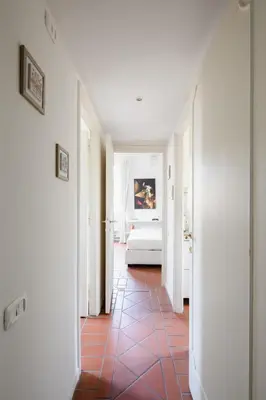 a hallway with a bedroom and a bed in a room at Casa Mandes Spanish Steps in Rome