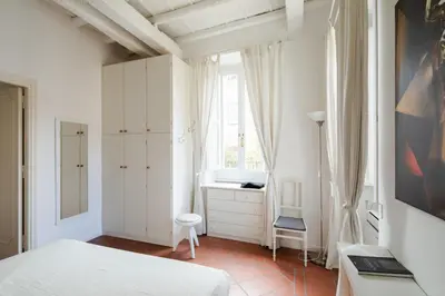 a white bedroom with a bed and a window at Casa Mandes Spanish Steps in Rome