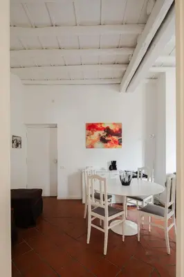 a white dining room with a white table and chairs at Casa Mandes Spanish Steps in Rome