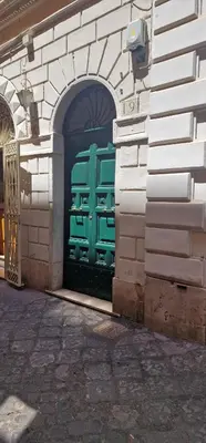 a green door on the side of a building at Casa Mandes Spanish Steps in Rome