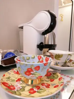 a tea cup and saucer on a counter with a lamp at Romebest in Rome