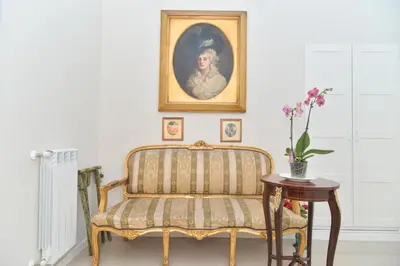 a chair in a room with a painting on the wall at Romebest in Rome