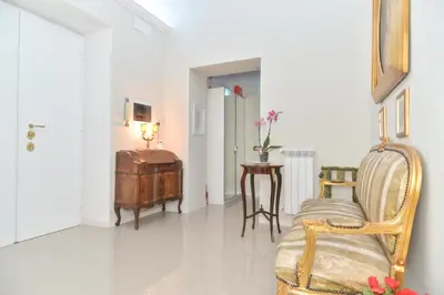 a living room with a chair and a table at Romebest in Rome