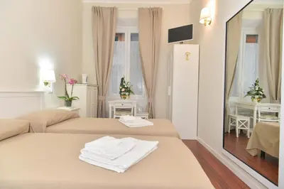 a hotel room with two beds and a mirror at Romebest in Rome