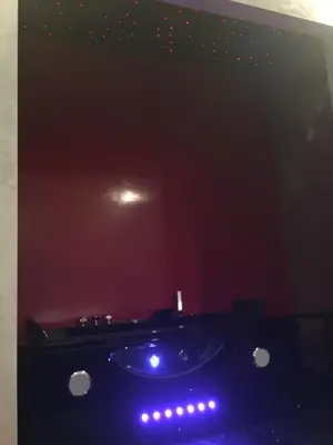 a dark bathroom with a tub with lights on it at B&B Roma Royal Residence in Rome