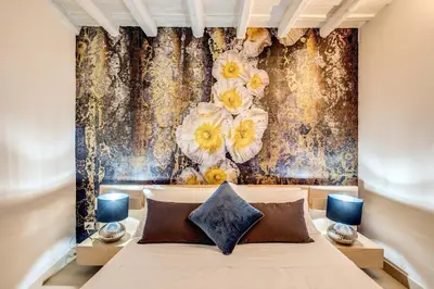 a bedroom with a bed and a floral wallpaper at YH Suite in Rome