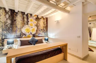 a bedroom with a bed with a floral wallpaper at YH Suite in Rome
