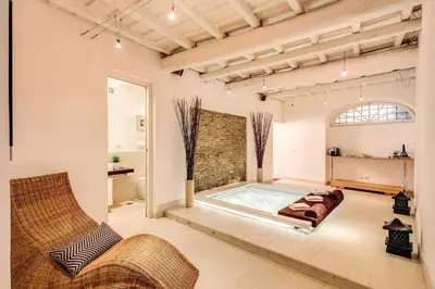 a large room with a hot tub in the middle at YH Suite in Rome