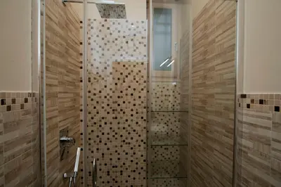 a bathroom with a shower with a glass door at Silenzioso Monolocale in Zona Parioli in Rome