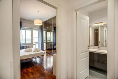 a bedroom with a bed and a sink and a mirror at Homely - spacious Apt in gianicolo district in Rome