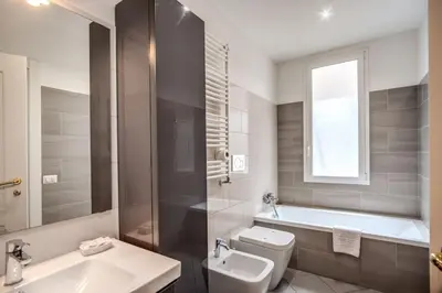 a bathroom with a tub and a toilet and a sink at Homely - spacious Apt in gianicolo district in Rome