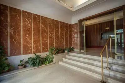 a lobby with stairs and plants in a building at Homely - spacious Apt in gianicolo district in Rome
