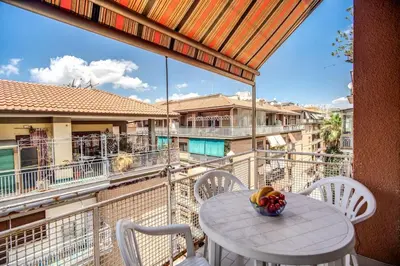 a table and chairs on a balcony with a view at Homely - spacious Apt in gianicolo district in Rome