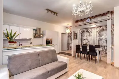 a living room with a couch and a table with chairs at Maison St Camillo Rome Centre in Rome