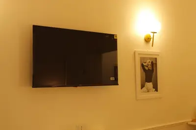 a flat screen tv hanging on a wall at Don Raffaele Resort Roma - Guest House in Trastevere