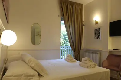 a bedroom with a bed with towels on it at Don Raffaele Resort Roma - Guest House in Trastevere