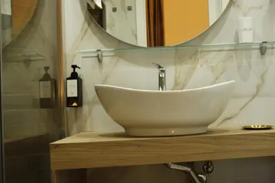 a bathroom with a sink and a mirror at Don Raffaele Resort Roma - Guest House in Trastevere