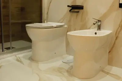 a bathroom with a toilet and a sink at Don Raffaele Resort Roma - Guest House in Trastevere