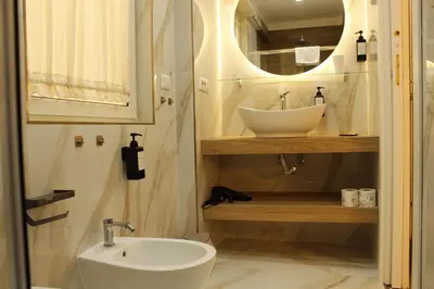 a bathroom with a sink and a mirror at Don Raffaele Resort Roma - Guest House in Trastevere