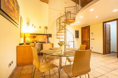 a dining room with a table and chairs at Il Nido -Cinema HD & Relax Space in Rome
