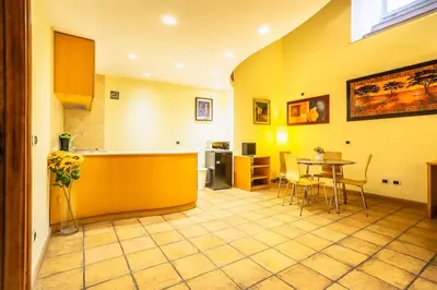 a kitchen and dining room with a table and chairs at Il Nido -Cinema HD & Relax Space in Rome