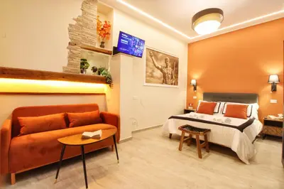 a hotel room with a bed and a couch at Domus Grottae at Campo de fiori in Rome