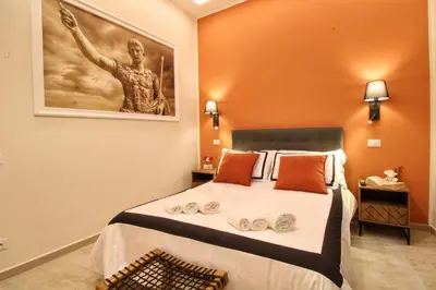 a bedroom with a bed with a painting on the wall at Domus Grottae at Campo de fiori in Rome