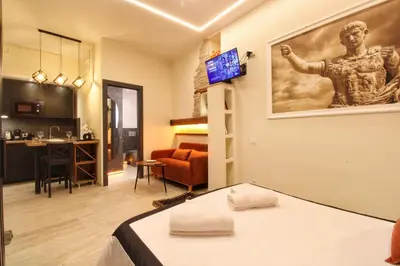 a room with a bed and a living room at Domus Grottae at Campo de fiori in Rome