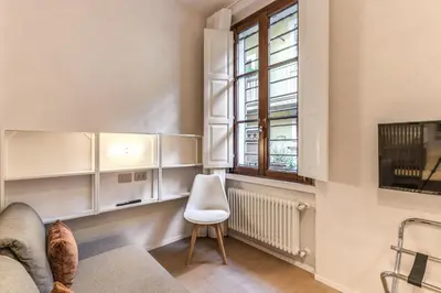 a living room with a couch and a window at Domus Romano Piazza Farnese in Rome
