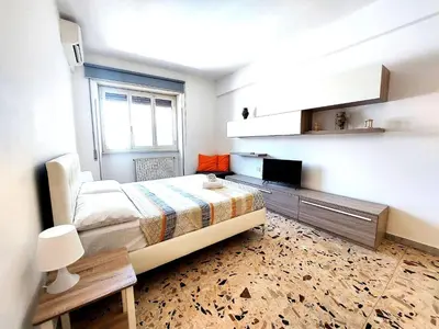 a bedroom with a bed and a television in it at Luminoso a due passi da Trastevere in Rome