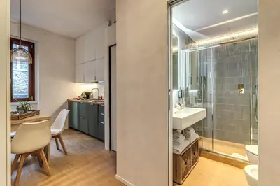 a bathroom with a sink and a glass shower at Domus Romano Campo de Fiori in Rome