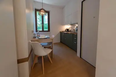 a kitchen with a table and chairs in a room at Domus Romano Campo de Fiori in Rome