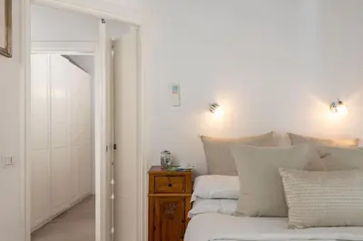 a bedroom with a bed and a table with pillows at NEW! Design apartment 2 min from Spanish Steps in Rome