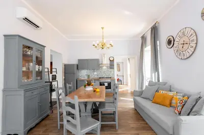 a kitchen and living room with a table and a couch at Big Flat in the Heart of Trastevere 4 bedrooms 3 bath in Rome