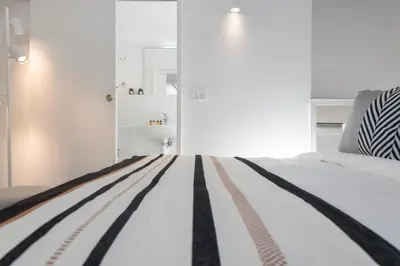 a bedroom with a bed with black and white stripes at Manara flats in the Heart of Trastevere in Rome