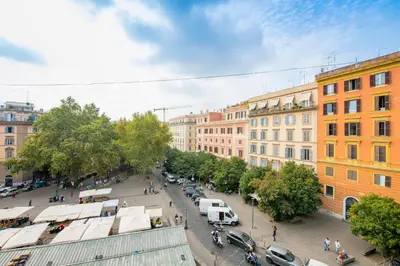 a street in a city with parked cars and buildings at Manara flats in the Heart of Trastevere in Rome