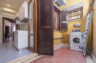 a laundry room with a washer and a washing machine at ht vicolo 6 bilo in Rome
