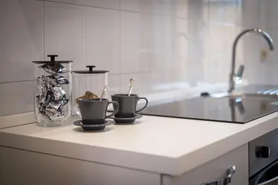 a kitchen counter with two coffee cups and a sink at ht vicolo 6 bilo in Rome