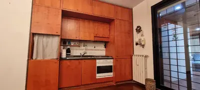a kitchen with wooden cabinets and a sink at Er Core Nostro in Rome