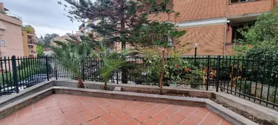a black fence with trees in front of a building at Er Core Nostro in Rome