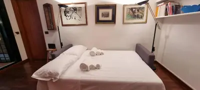 a bed in a room with two pillows on it at Er Core Nostro in Rome