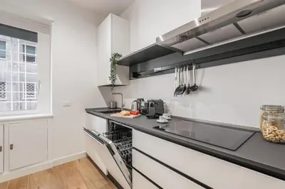 a kitchen with white walls and a black counter top at The Best Rent - Spacious three-bedroom apartment in Prati area in Rome