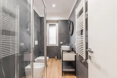 a bathroom with a sink and a toilet and a shower at The Best Rent - Spacious three-bedroom apartment in Prati area in Rome